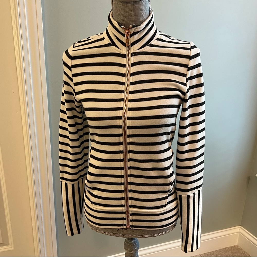Black and cream fitted striped full front zip sweatshirt jacket w/ side pockets.